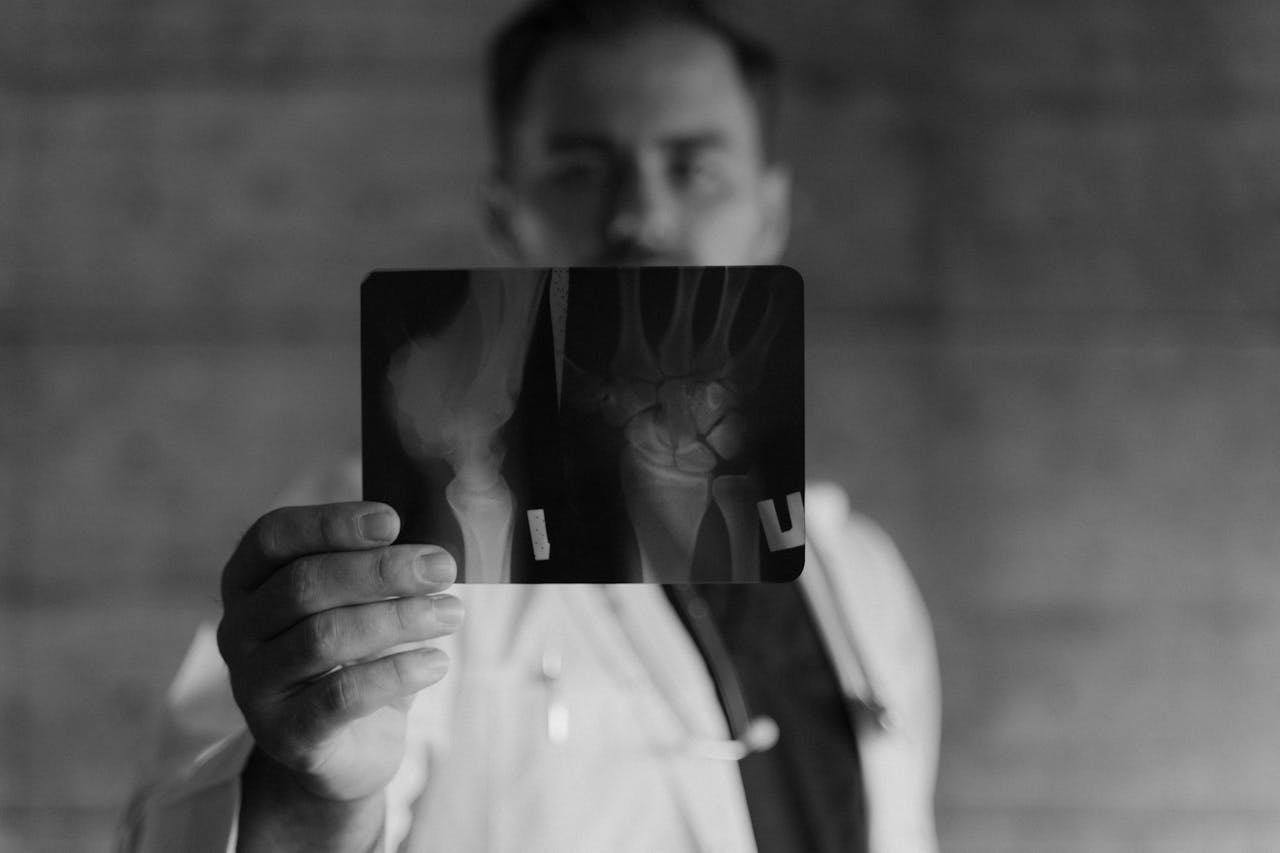 Focused medical professional examining a bone x-ray image.